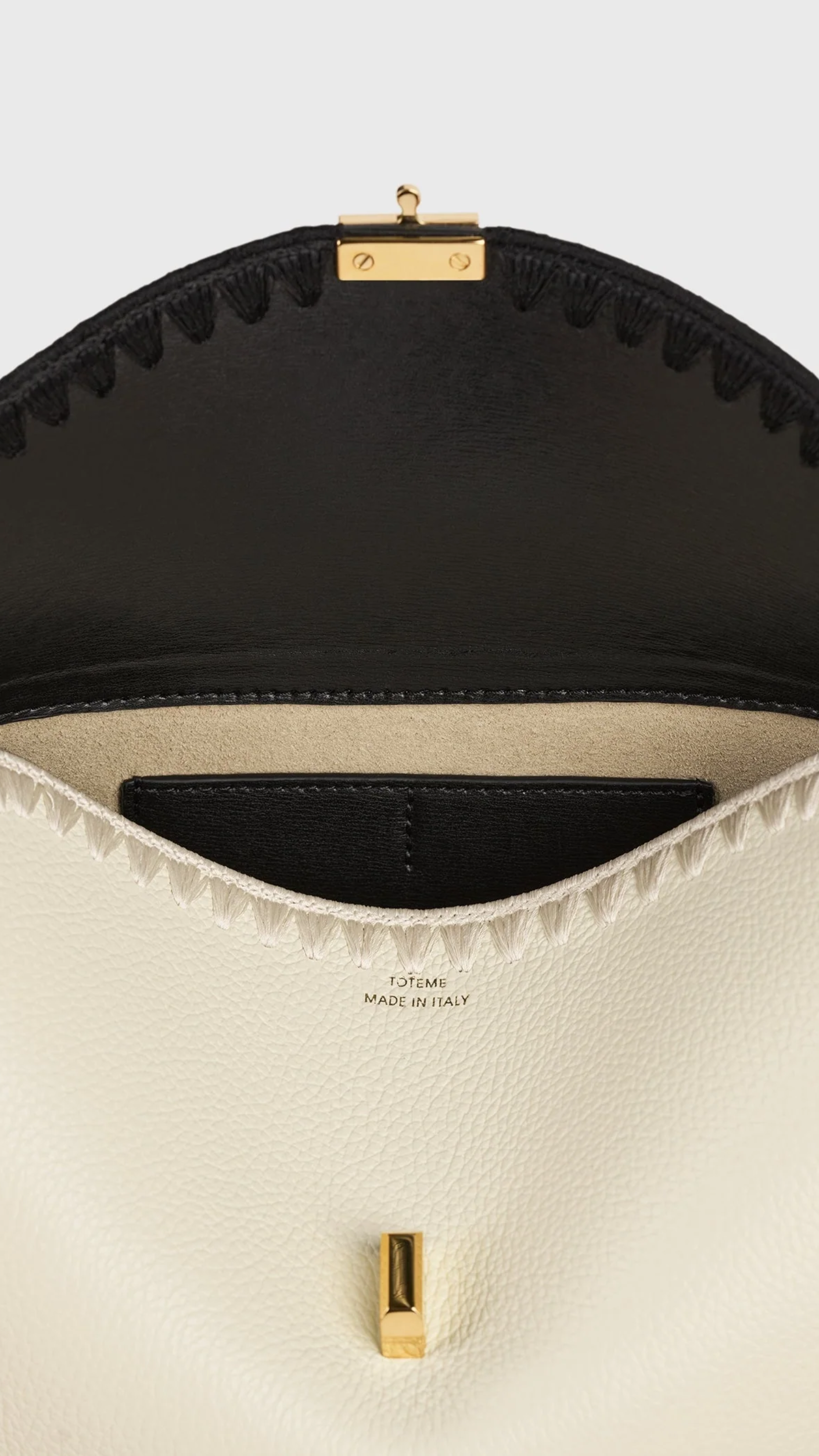 Toteme T-lock Embroidered Leather Clutch in Black Milk