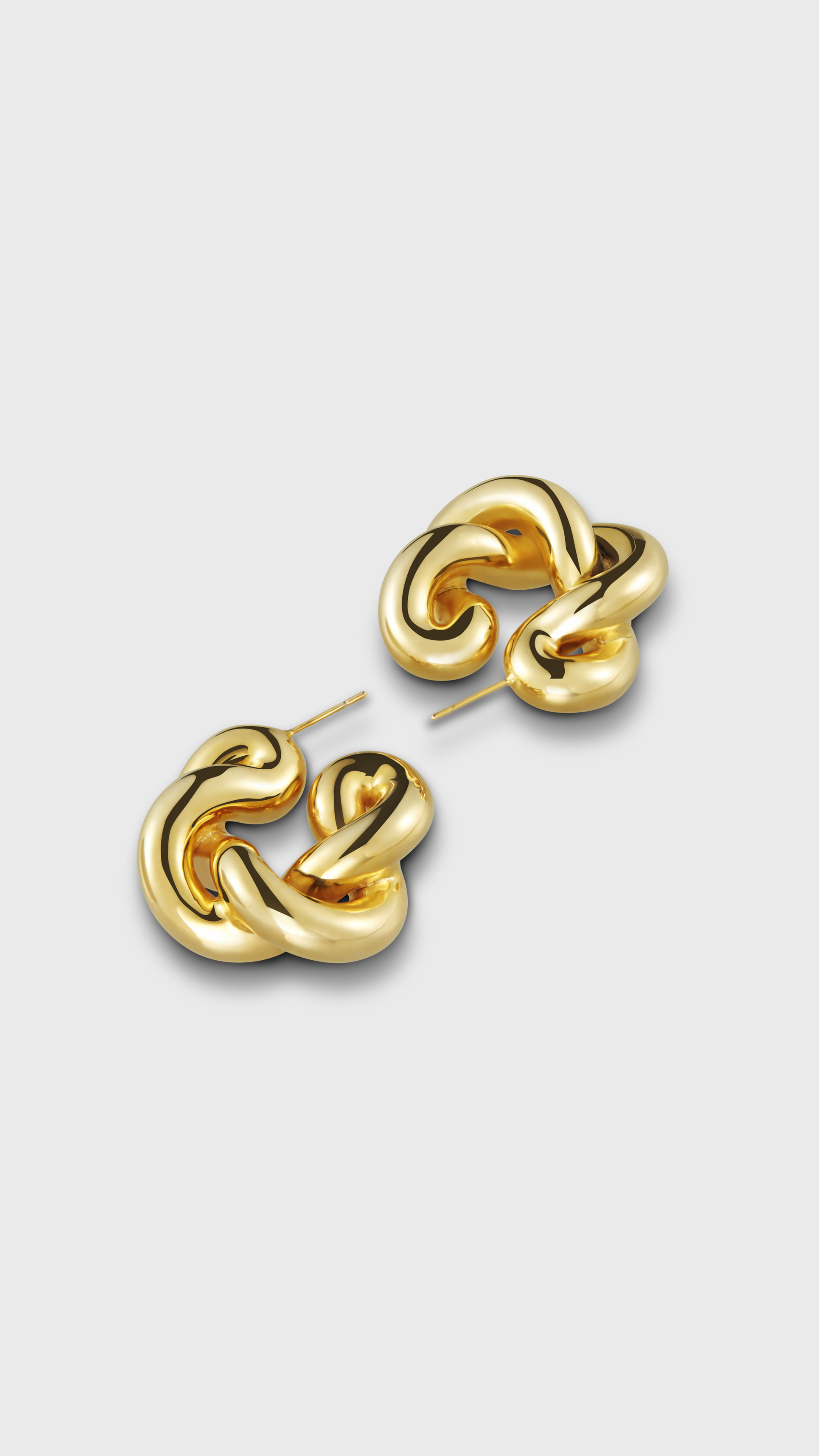 Uncommon Matters Twist Creoles Earrings in Gold